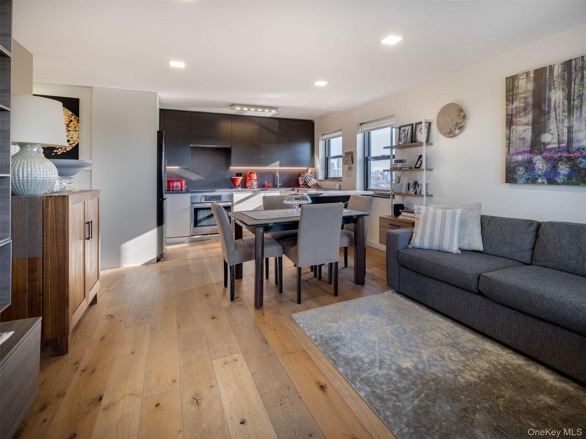 25-40 Shore Boulevard, Unit 17K Queens, NY 11102 - Photo 4 of 19 a living room with furniture and a wooden floor