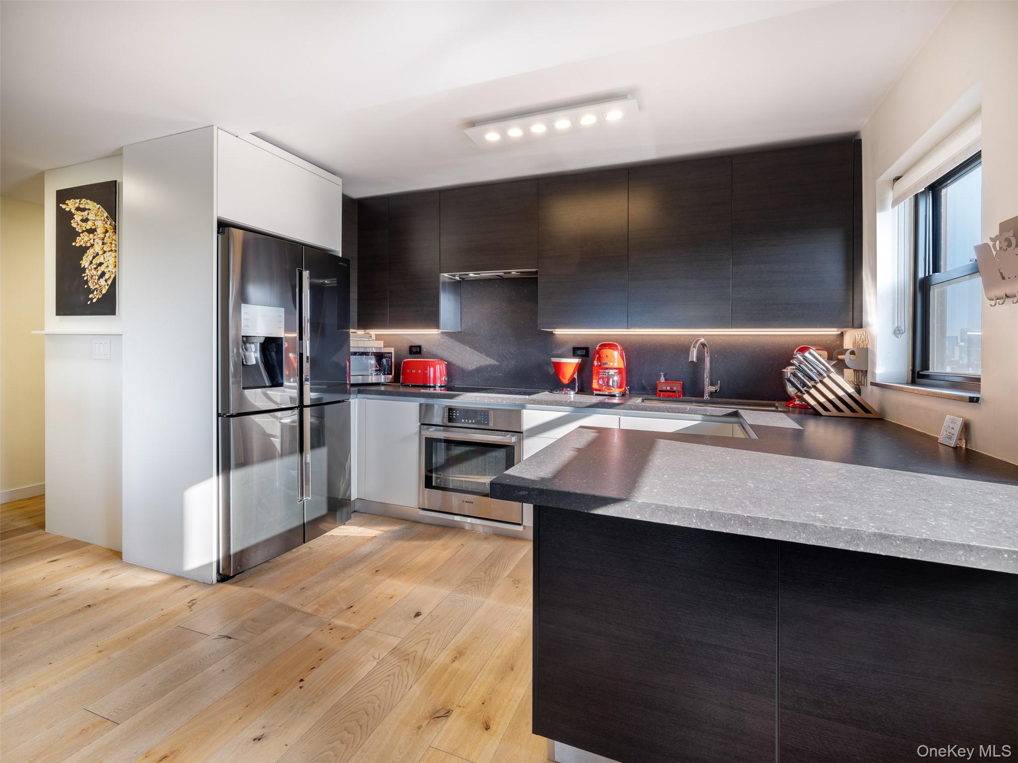 25-40 Shore Boulevard, Unit 17K Queens, NY 11102 - Photo 6 of 19 a kitchen with stainless steel appliances granite countertop a sink stove and refrigerator