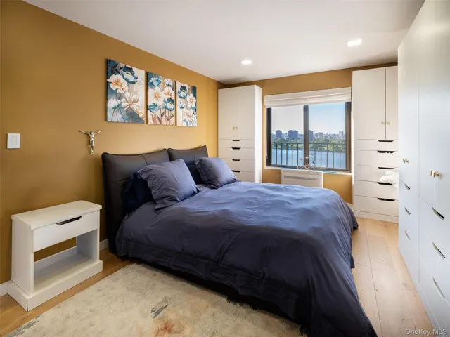 a bedroom with a bed and a large window