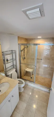 a bathroom with a toilet sink and shower