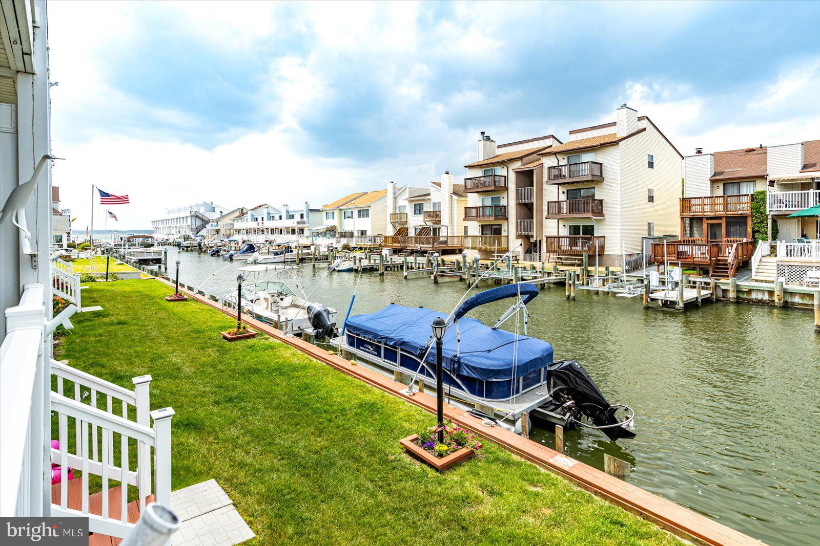 722 Mooring Road, Unit A104 Ocean City, MD 21842 - Photo 29 of 33 a view of a lake with a chairs and table on the terrace