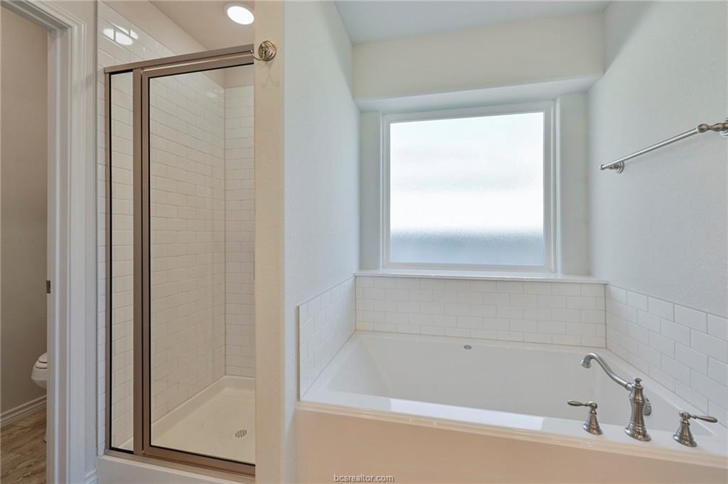 3124 Tarleton Court Bryan, TX 77808 - Photo 13 of 22 a bathroom with a bathtub