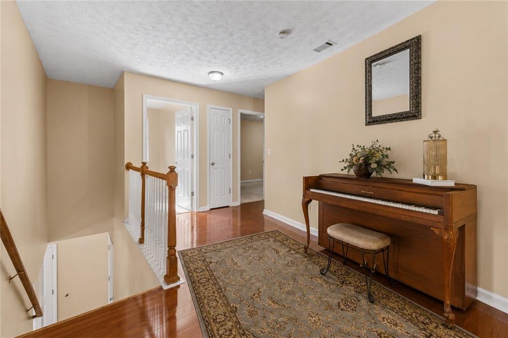 2760 Rusticwood Drive Southwest Snellville, GA 30078 - Photo 19 of 50 a view of a hallway a room with wooden floor and furniture