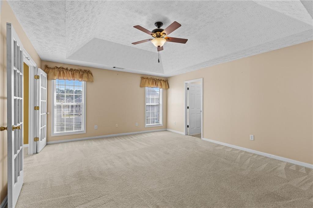 2760 Rusticwood Drive Southwest Snellville, GA 30078 - Photo 20 of 50 a view of an empty room with a ceiling fan and window