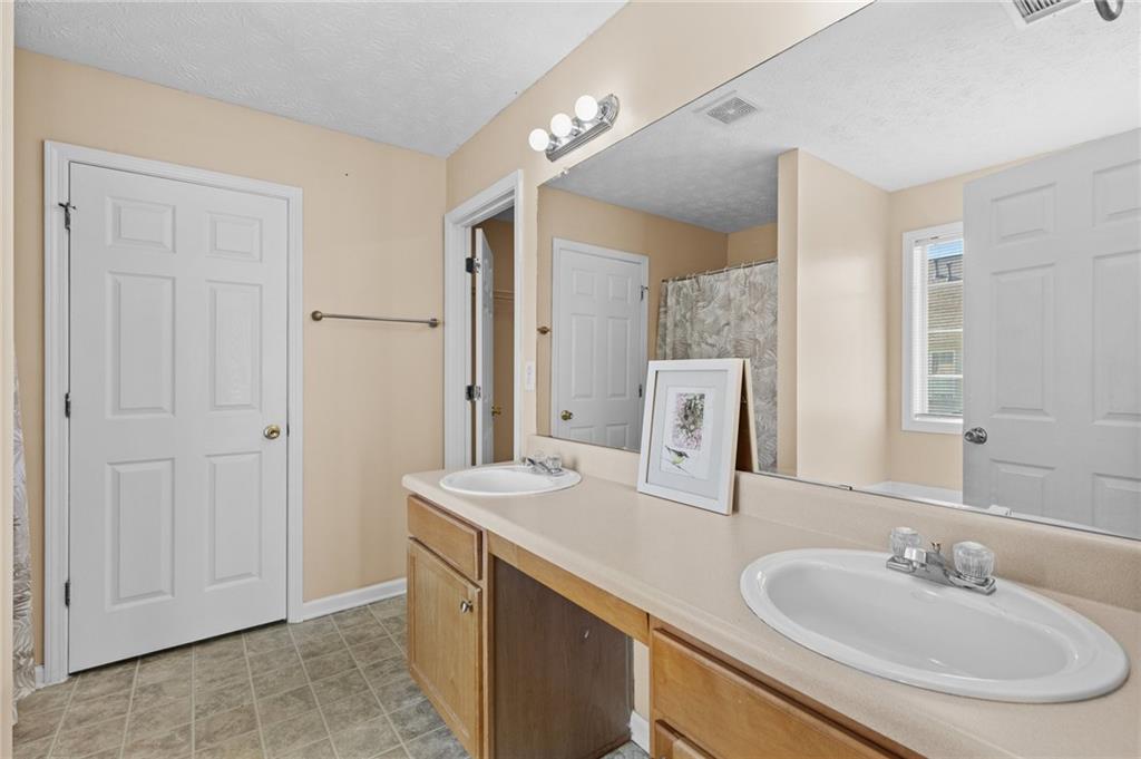 2760 Rusticwood Drive Southwest Snellville, GA 30078 - Photo 27 of 50 a bathroom with a sink and a mirror