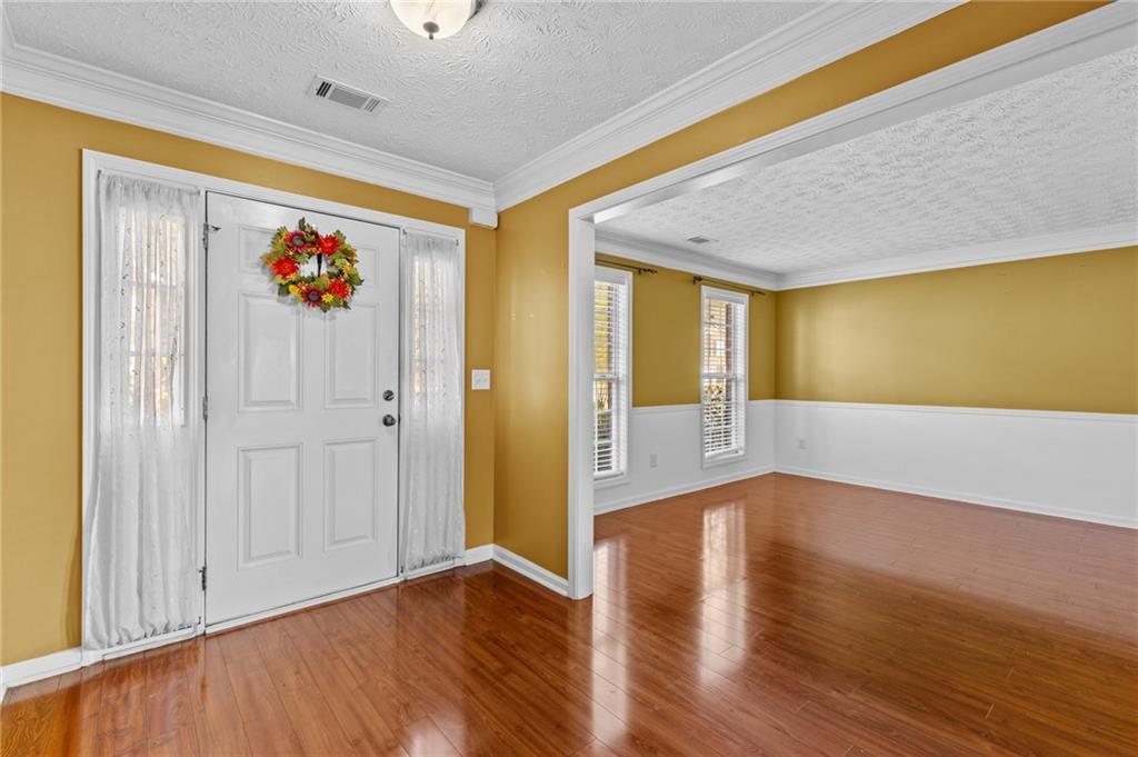 2760 Rusticwood Drive Southwest Snellville, GA 30078 - Photo 3 of 50 a view of a hallway with wooden floor and chandelier
