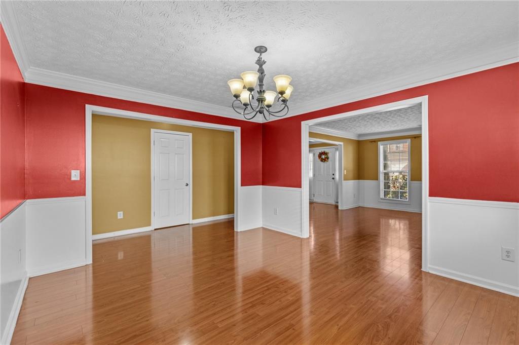 2760 Rusticwood Drive Southwest Snellville, GA 30078 - Photo 9 of 50 a view of a hallway with wooden floor and a chandelier