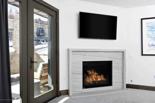 a living room with a fireplace and a flat screen tv