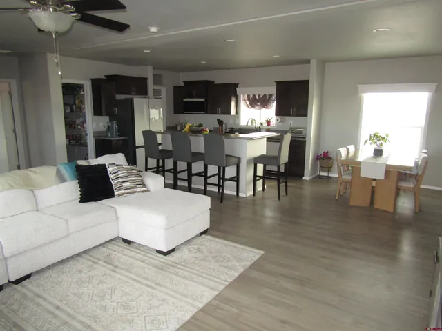a living room with lots of furniture and kitchen view
