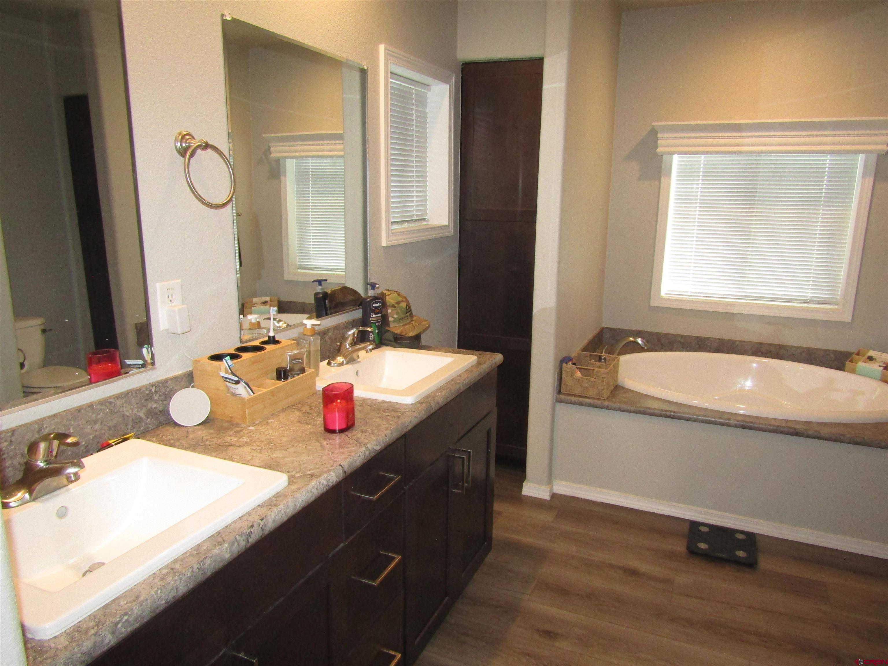 4784 Alpine Ranch Alamosa, CO 81101 - Photo 8 of 15 a bathroom with a granite countertop sink and a mirror