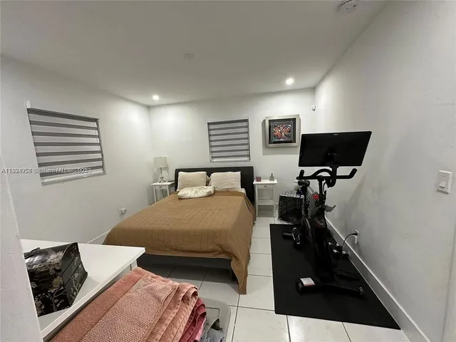 a bedroom with furniture and a flat screen tv