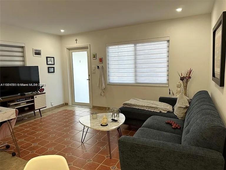 4485 Southwest 7th Street, Unit 4485 Miami, FL 33134 - Photo 2 of 12 a living room with furniture and a flat screen tv