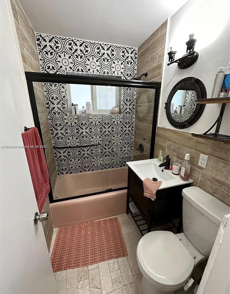 4485 Southwest 7th Street, Unit 4485 Miami, FL 33134 - Photo 10 of 12 a bathroom with a sink mirror vanity and toilet