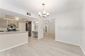 a view of a kitchen with a sink and a refrigerator
