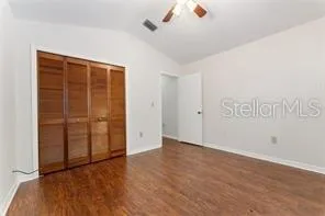 an empty room with wooden floor