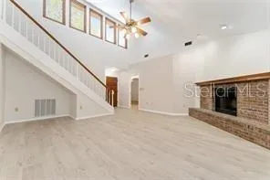 a view of an empty room with a fireplace