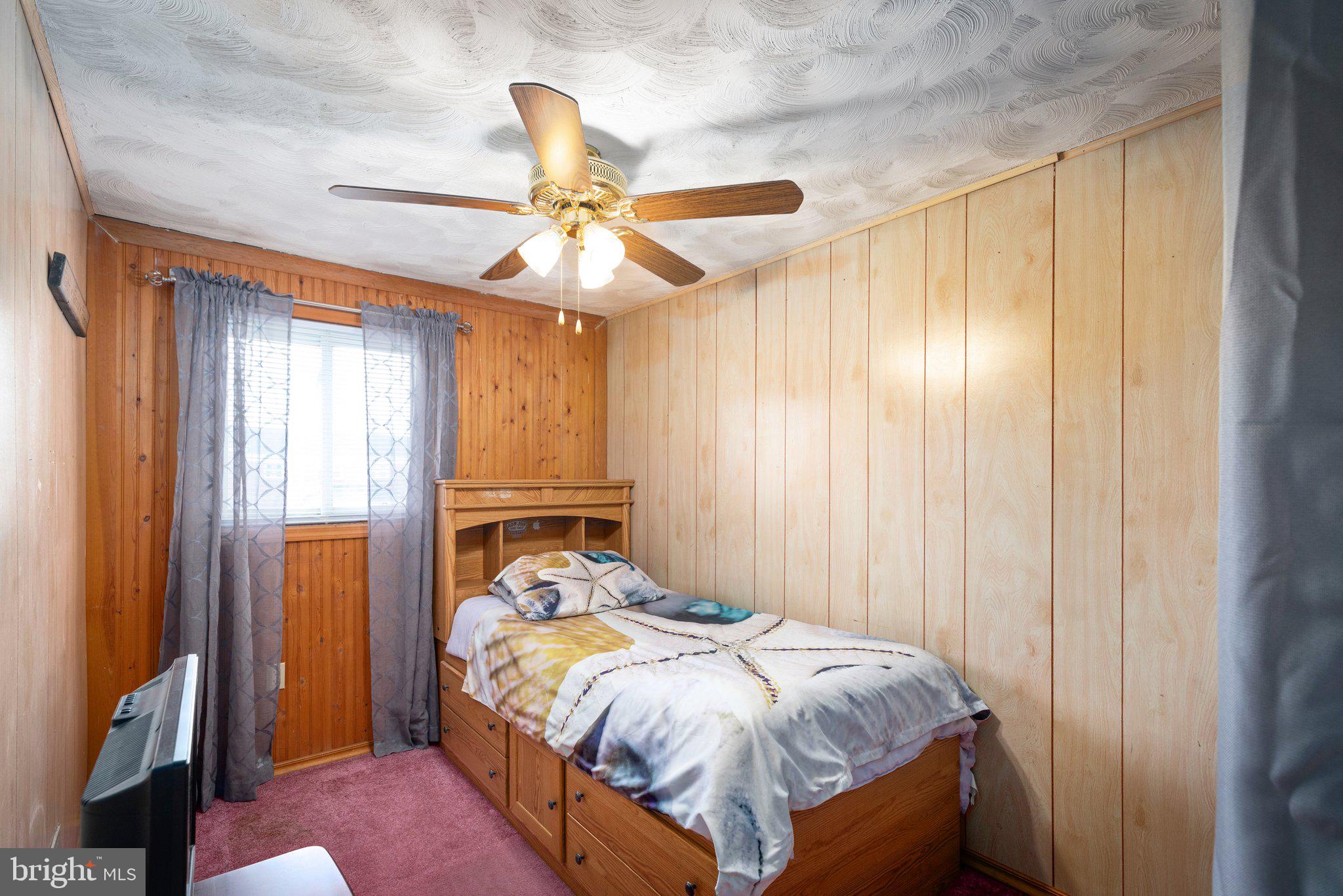 7404 Edsworth Road Dundalk, MD 21222 - Photo 14 of 24 a bed sitting in a spacious bedroom next to a window