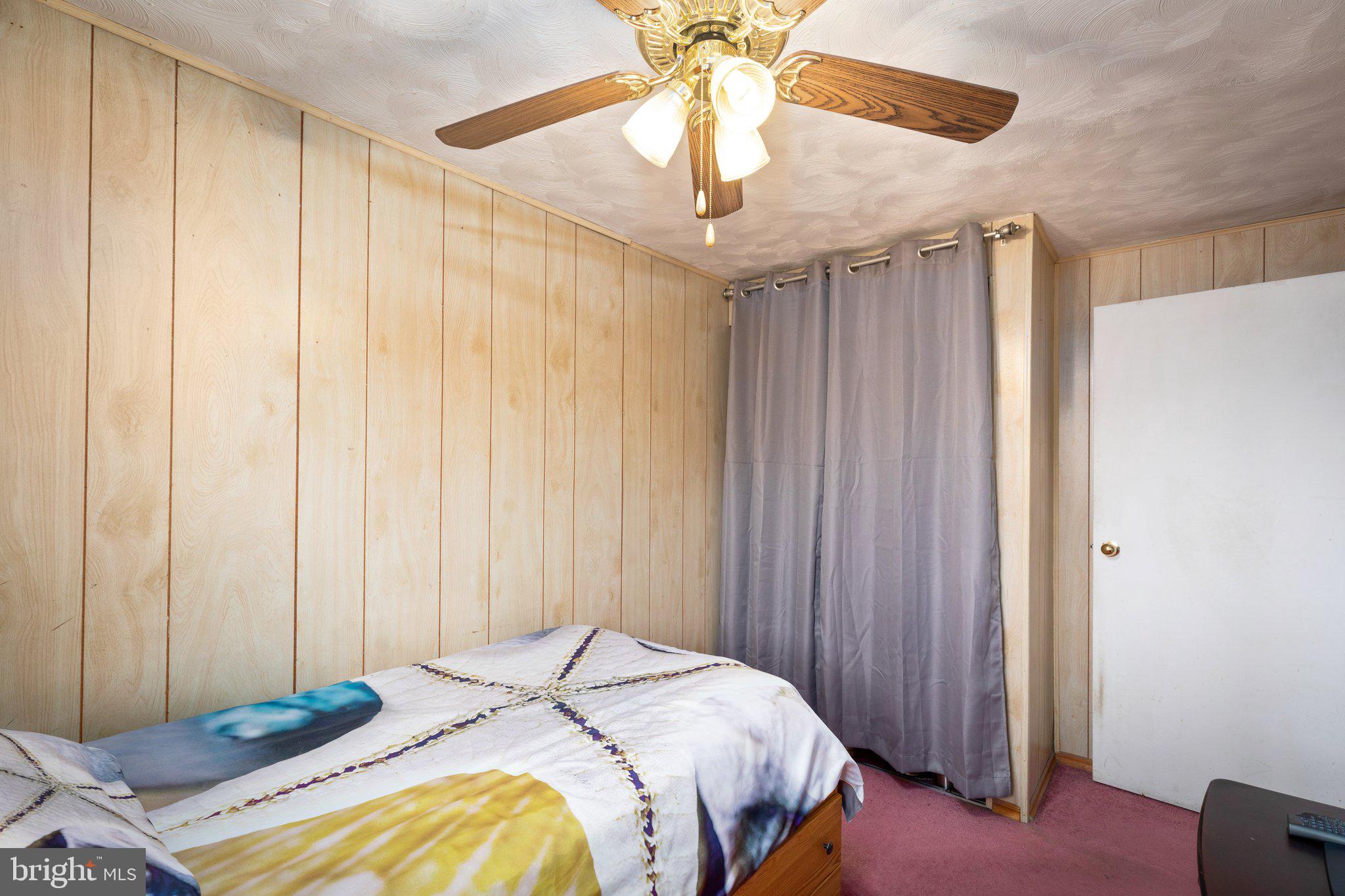 7404 Edsworth Road Dundalk, MD 21222 - Photo 15 of 24 a bedroom with a bed and a chandelier