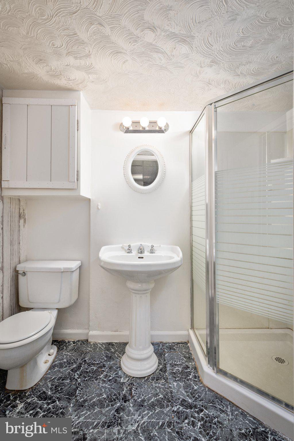 7404 Edsworth Road Dundalk, MD 21222 - Photo 21 of 24 a bathroom with a sink toilet and shower