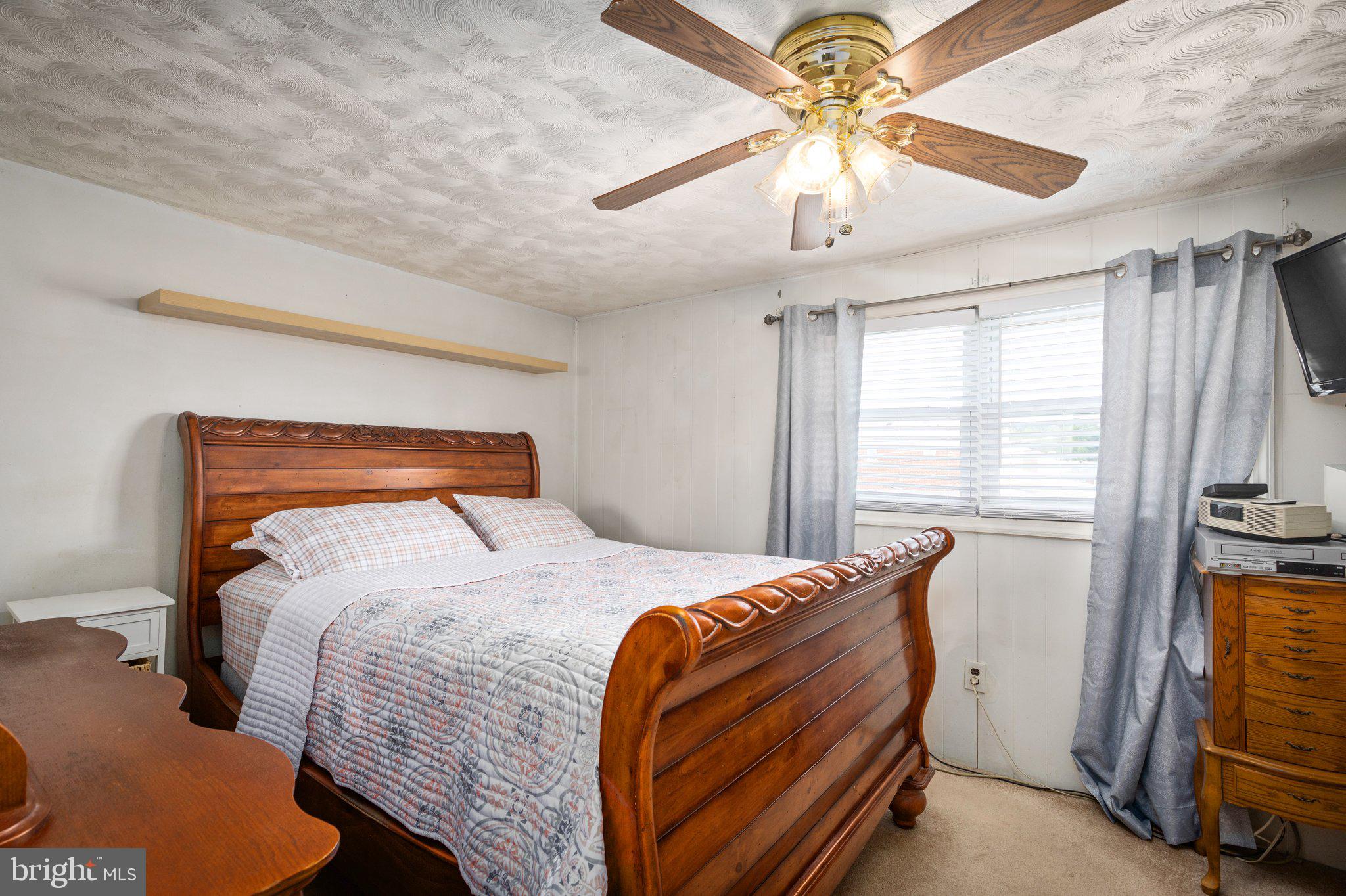 7404 Edsworth Road Dundalk, MD 21222 - Photo 10 of 24 a bedroom with a bed and a chandelier