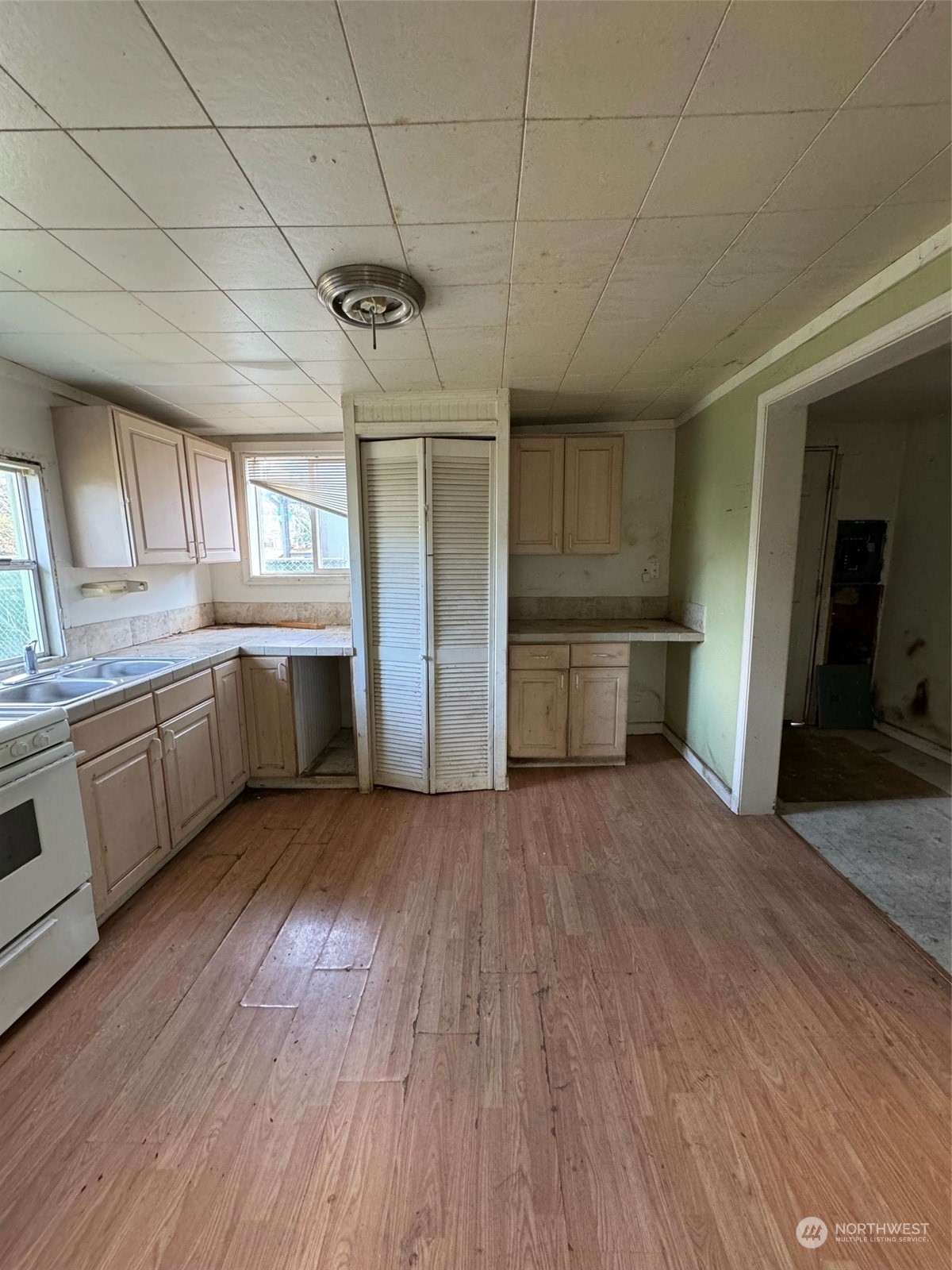 1521 North 3rd Street Renton, WA 98057 - Photo 7 of 10 a large kitchen with a wooden floor and stainless steel appliances
