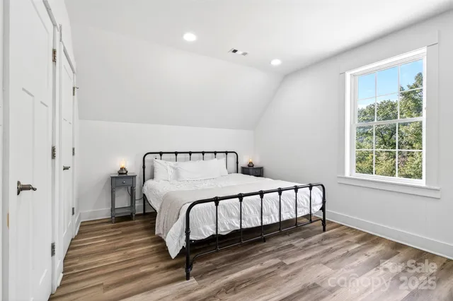 a bedroom with a bed and a window