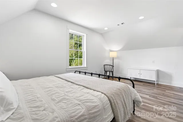 a bedroom with a bed and a large window