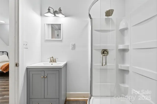 a bathroom with a sink a toilet and shower