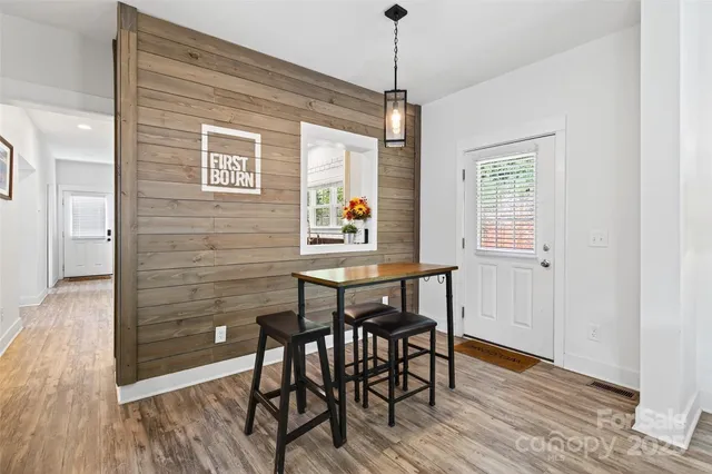 a view of a dining room with furniture window and wooden floor