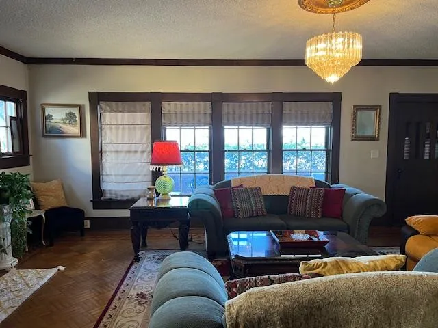 a living room with furniture a rug and a window