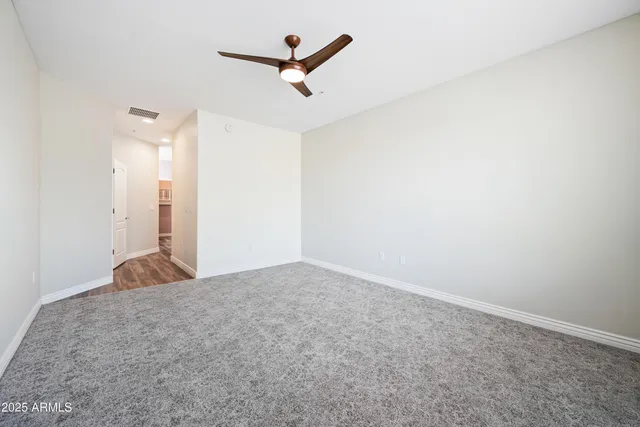 a bedroom with a bed a chandelier and a couch