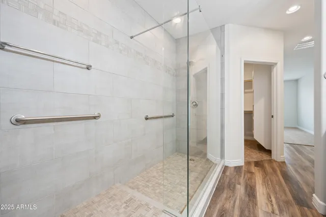 a bathroom with a granite countertop sink mirror and shower