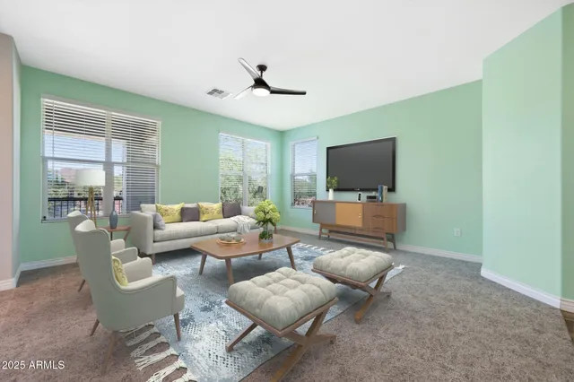 a view of a livingroom with a ceiling fan and window