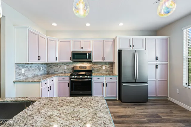 a kitchen with a sink stove and microwave