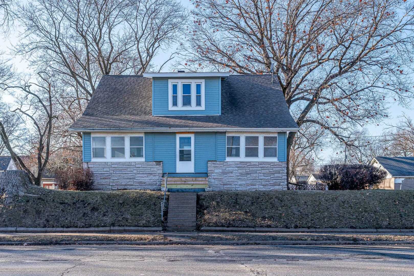 1320 11th Street Rock Island, IL 61201 - Photo 1 of 16 a front view of a house with garage