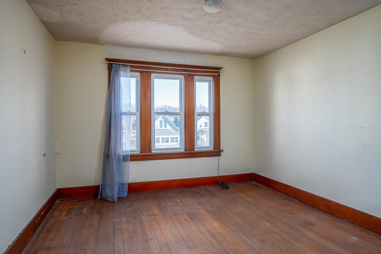 1320 11th Street Rock Island, IL 61201 - Photo 12 of 16 an empty room with wooden floor and windows