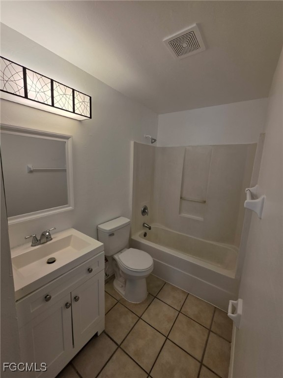 1248 Columbus Boulevard, Unit B Fort Myers, FL 33913 - Photo 11 of 16 a bathroom with a granite countertop sink toilet and shower
