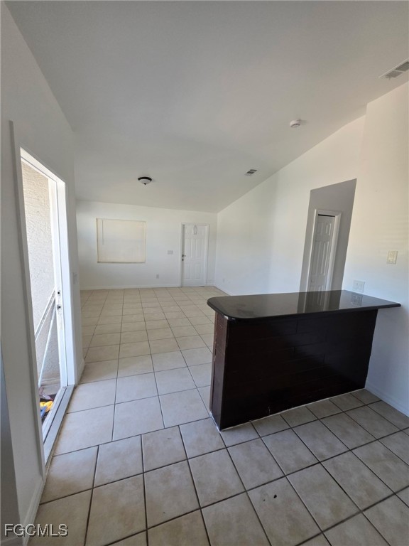 1248 Columbus Boulevard, Unit B Fort Myers, FL 33913 - Photo 12 of 16 a view of an empty room with wooden cabinet