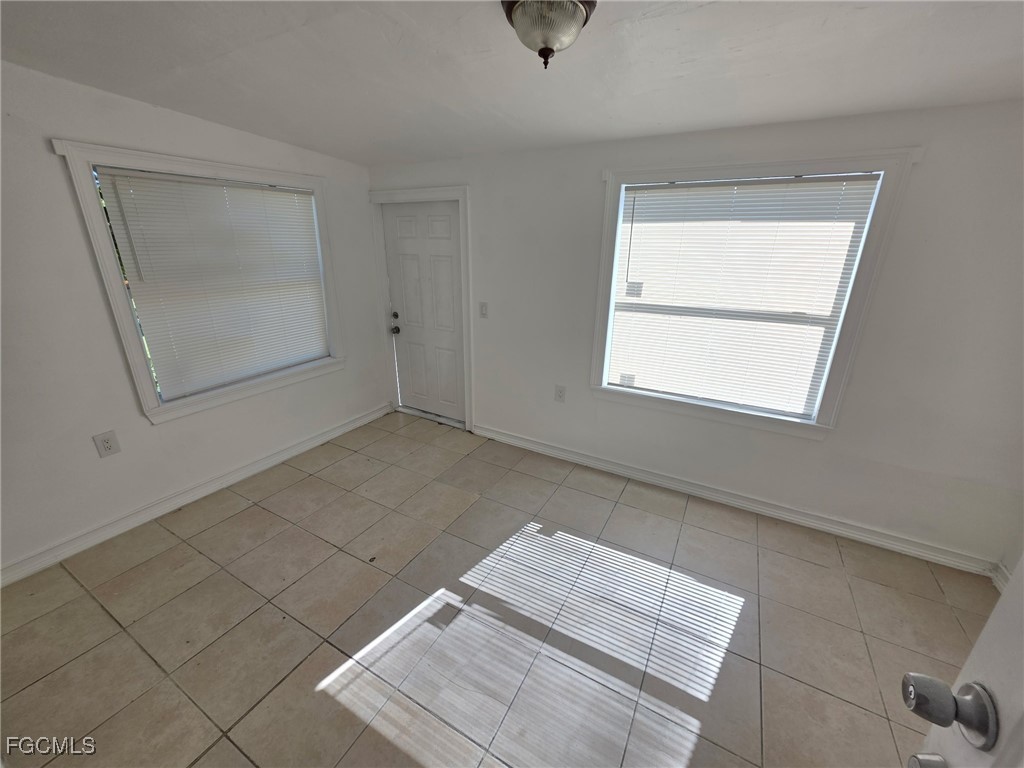 1248 Columbus Boulevard, Unit B Fort Myers, FL 33913 - Photo 4 of 16 an empty room with windows