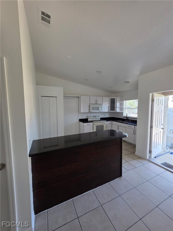 1248 Columbus Boulevard, Unit B Fort Myers, FL 33913 - Photo 5 of 16 a kitchen with granite countertop a refrigerator and a sink