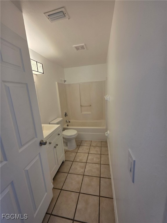 1248 Columbus Boulevard, Unit B Fort Myers, FL 33913 - Photo 8 of 16 a bathroom with a sink a toilet and a mirror