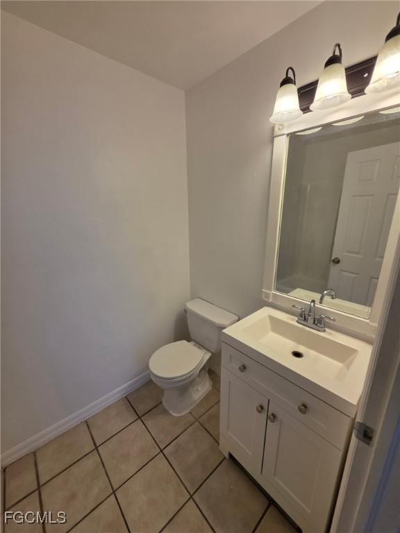1248 Columbus Boulevard, Unit B Fort Myers, FL 33913 - Photo 9 of 16 a bathroom with a toilet sink and mirror