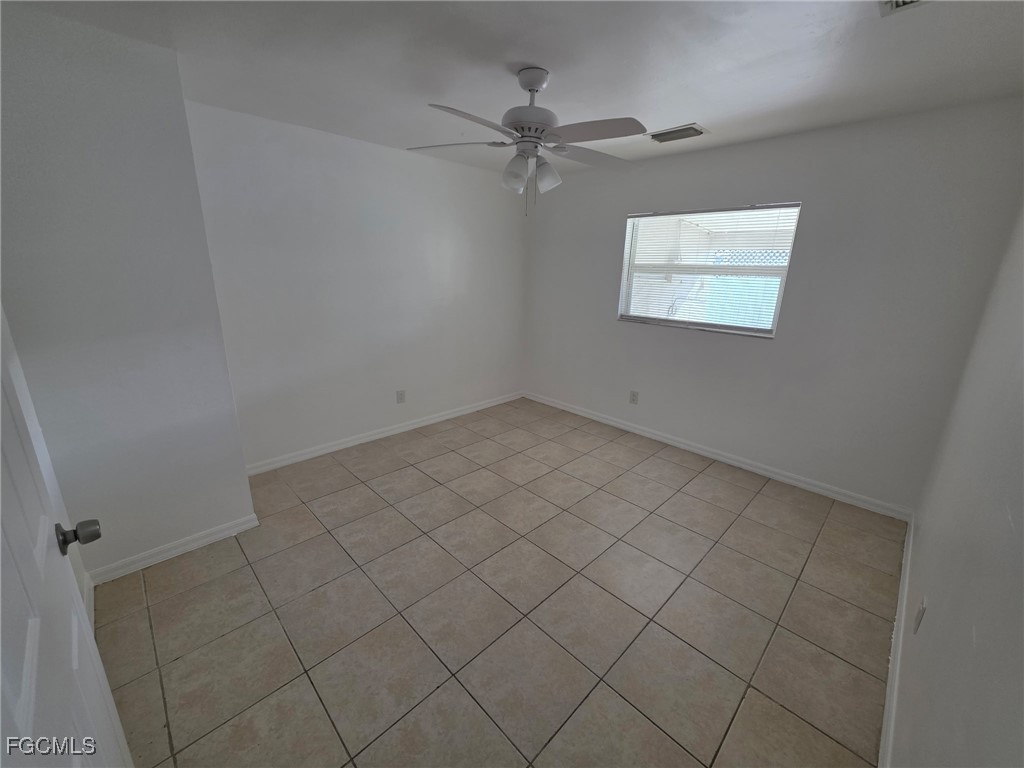 1248 Columbus Boulevard, Unit B Fort Myers, FL 33913 - Photo 10 of 16 an empty room with a ceiling fan