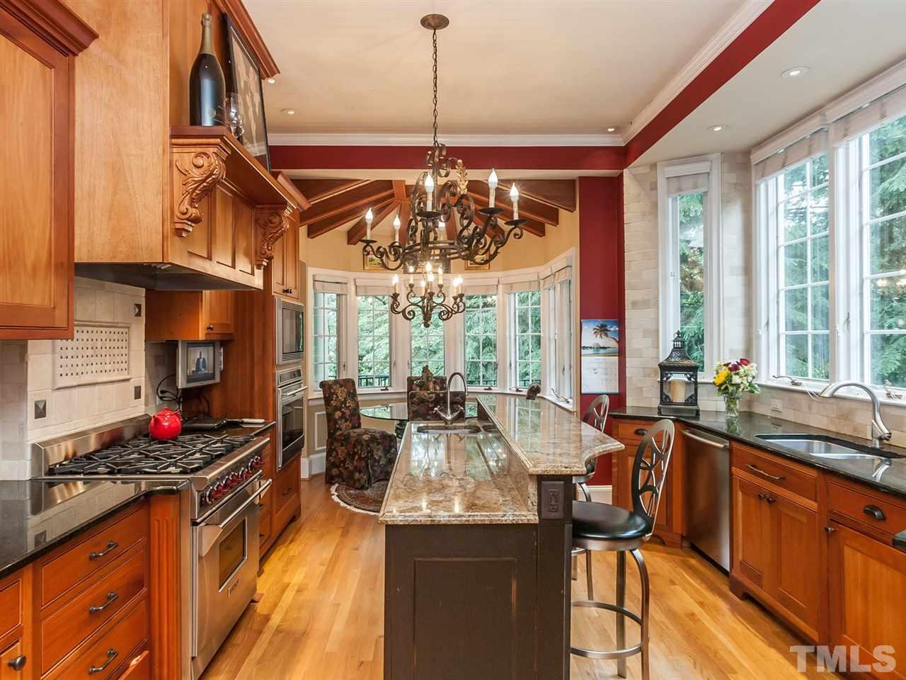 1553 Carr Raleigh, NC 27608 - Photo 8 of 25 a very nice looking kitchen with granite countertop a stove and a large window