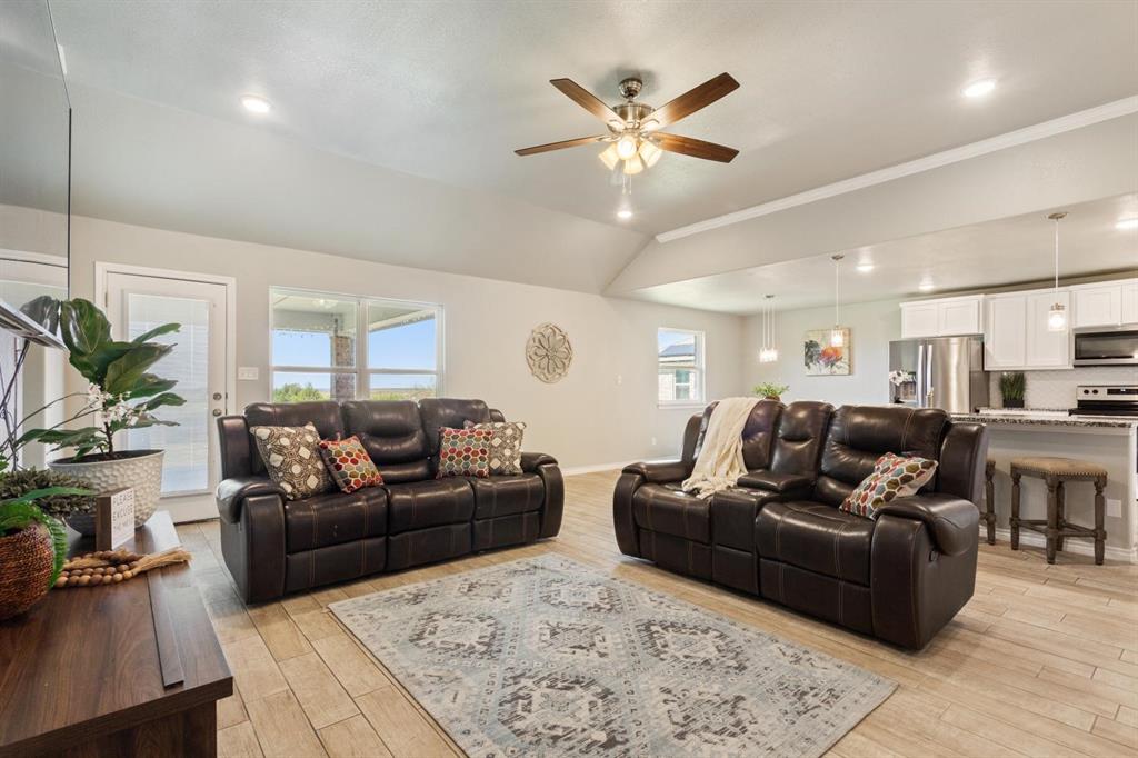 8876 1237 Spur Troy, TX 76579 - Photo 11 of 31 a living room with furniture and a chandelier