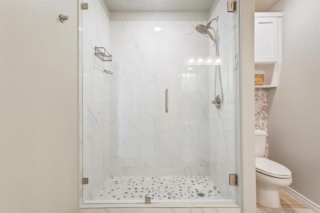 8876 1237 Spur Troy, TX 76579 - Photo 20 of 31 a bathroom with a shower and a toilet