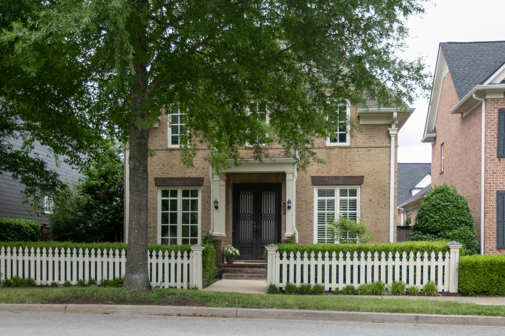 a front view of a house with a garden