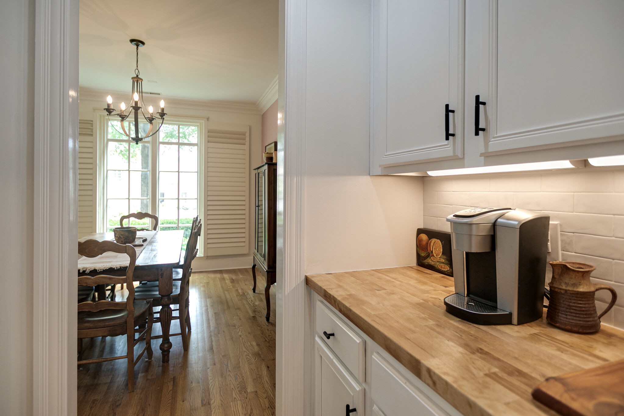 126 Addison Avenue Franklin, TN 37064 - Photo 11 of 38 a kitchen with stainless steel appliances granite countertop a dining table chairs and chandelier