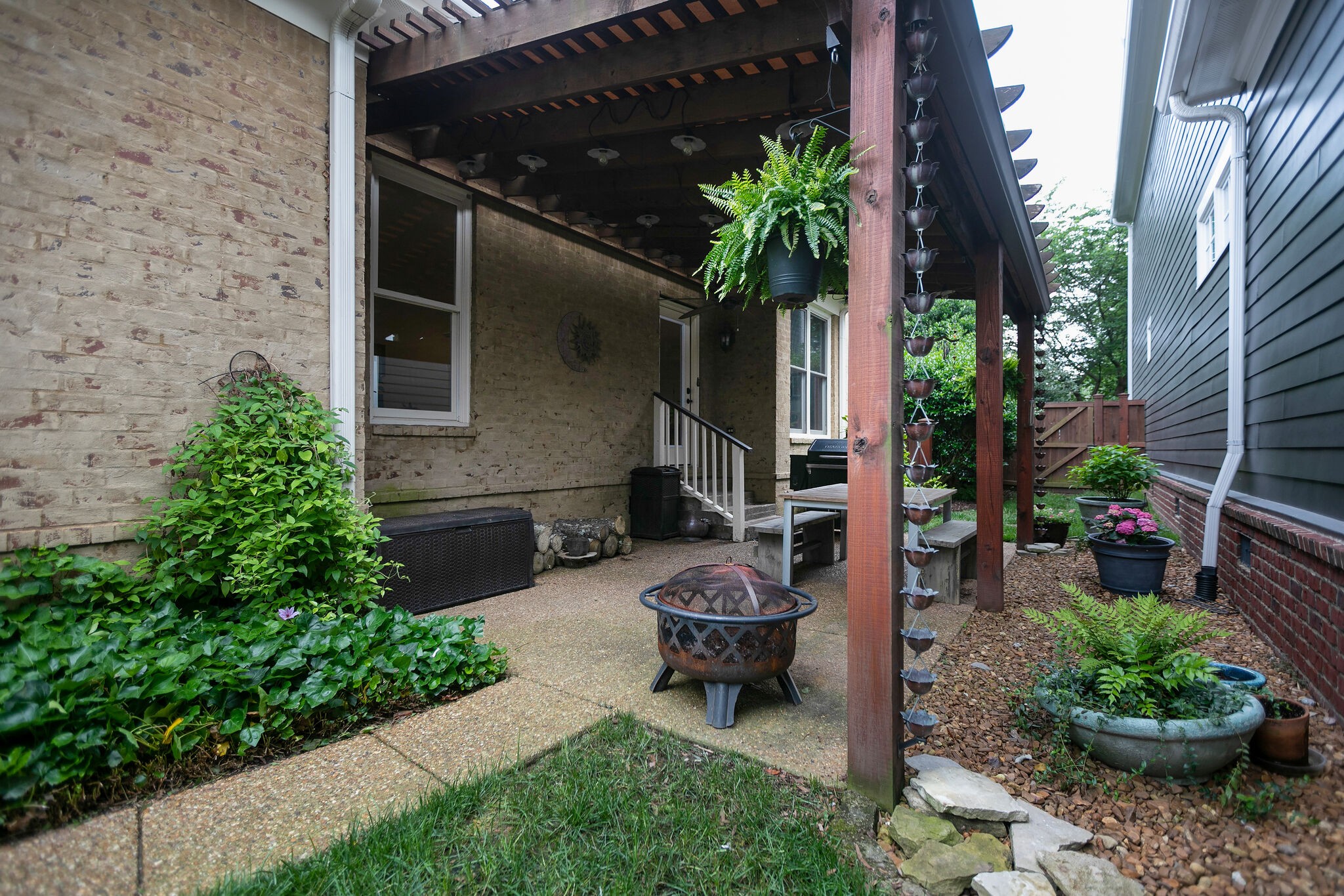 126 Addison Avenue Franklin, TN 37064 - Photo 36 of 38 a backyard of a house with lots of green space and a fountain