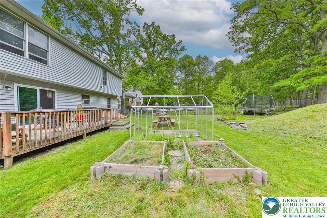 4608 Pine Ridge Drive West Bushkill, PA 18324 - Photo 50 of 62 A spacious backyard with raised garden beds and a greenhouse awaits your green thumb.